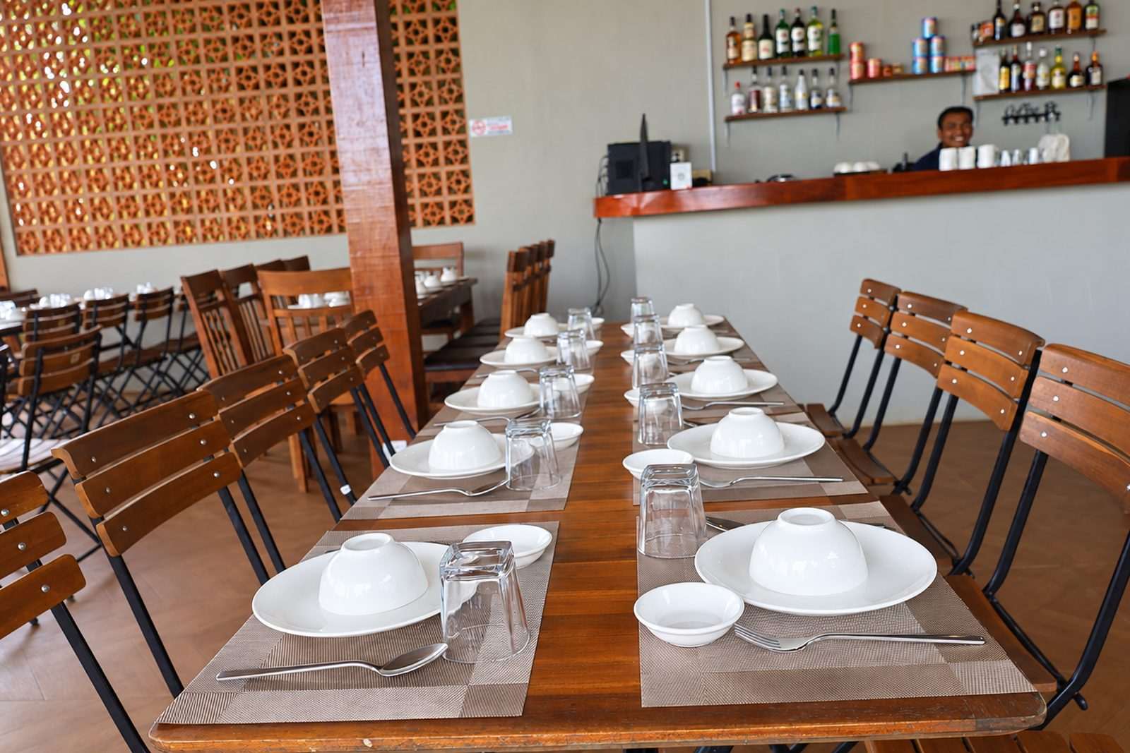 The restaurant bar and long communal tables set for service