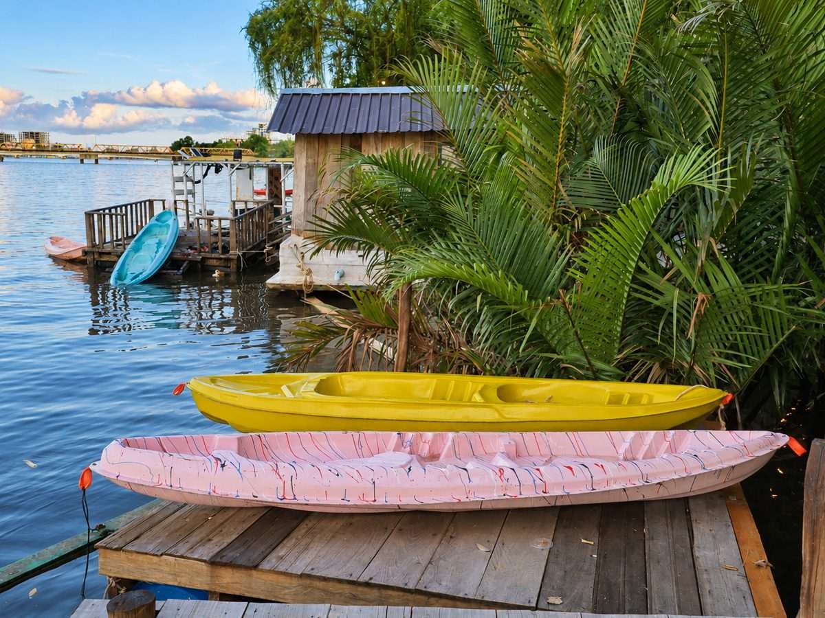 Two kayaks resting on the floating dock at the river’s edge